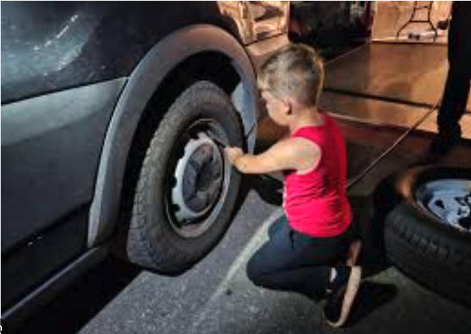kid fixing flat tire